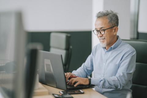 Man at work looking at a computer monitor